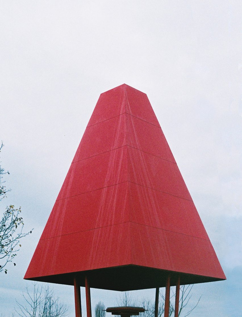 A pavilion with a red hip roof
