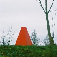 A bright red pavilion in a park