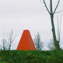 A bright red pavilion in a park