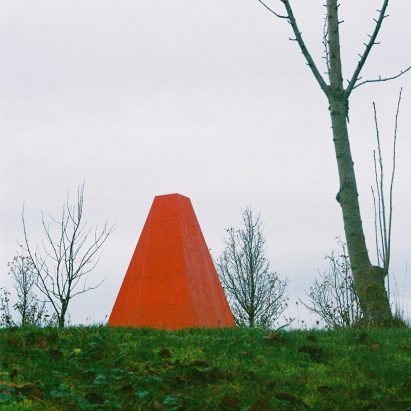 A bright red pavilion in a park