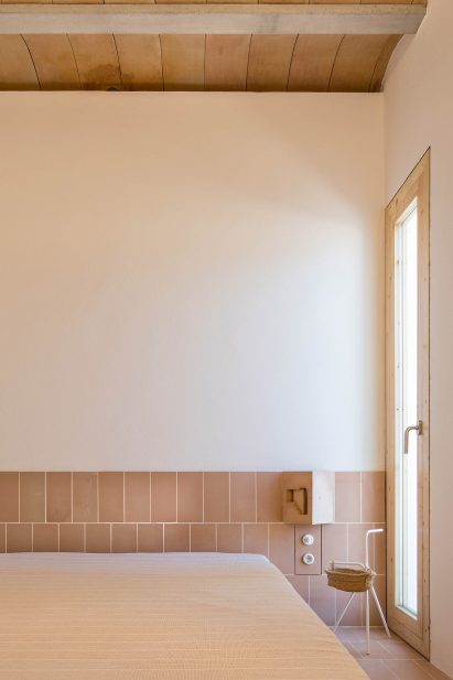 The bedroom has a tiled baseboard by Maria Castello