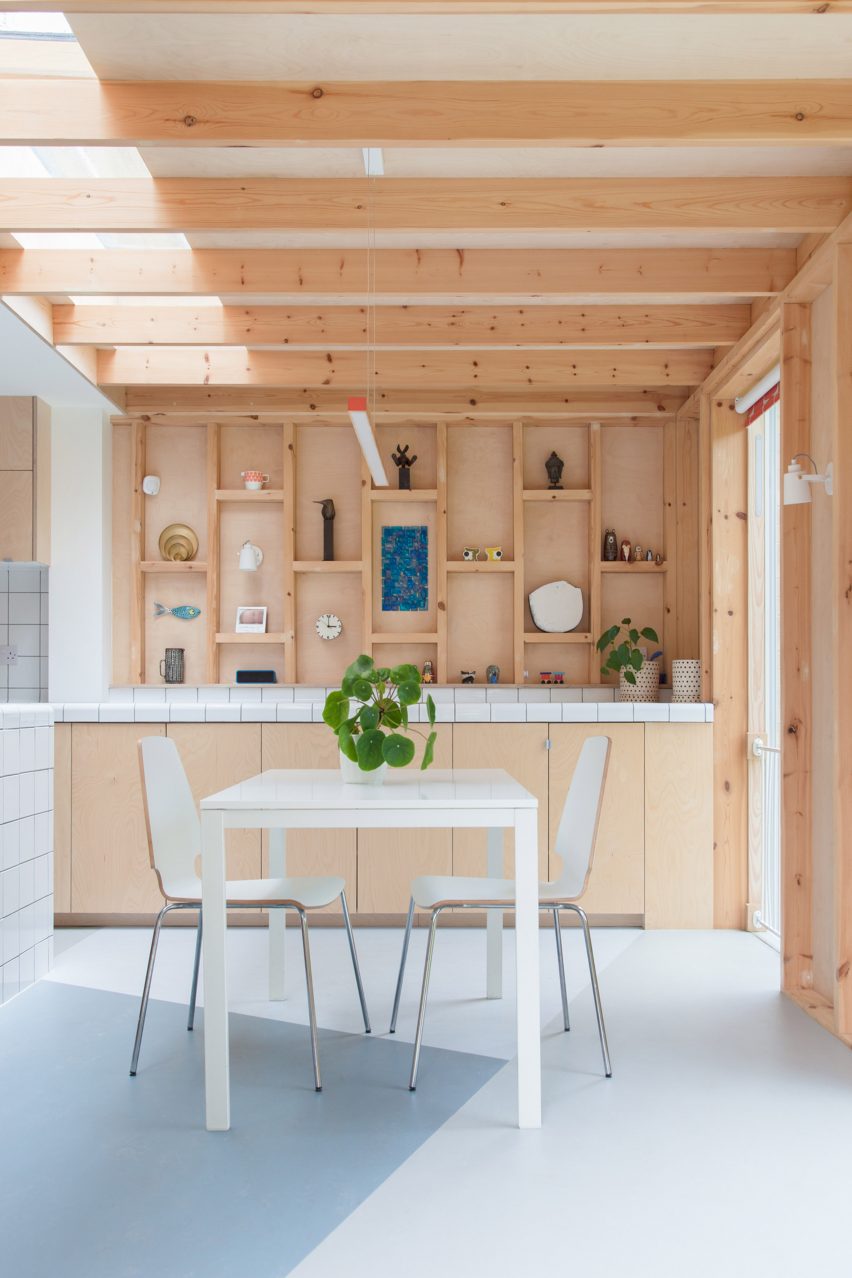 A kitchen with wooden walls and cabinets