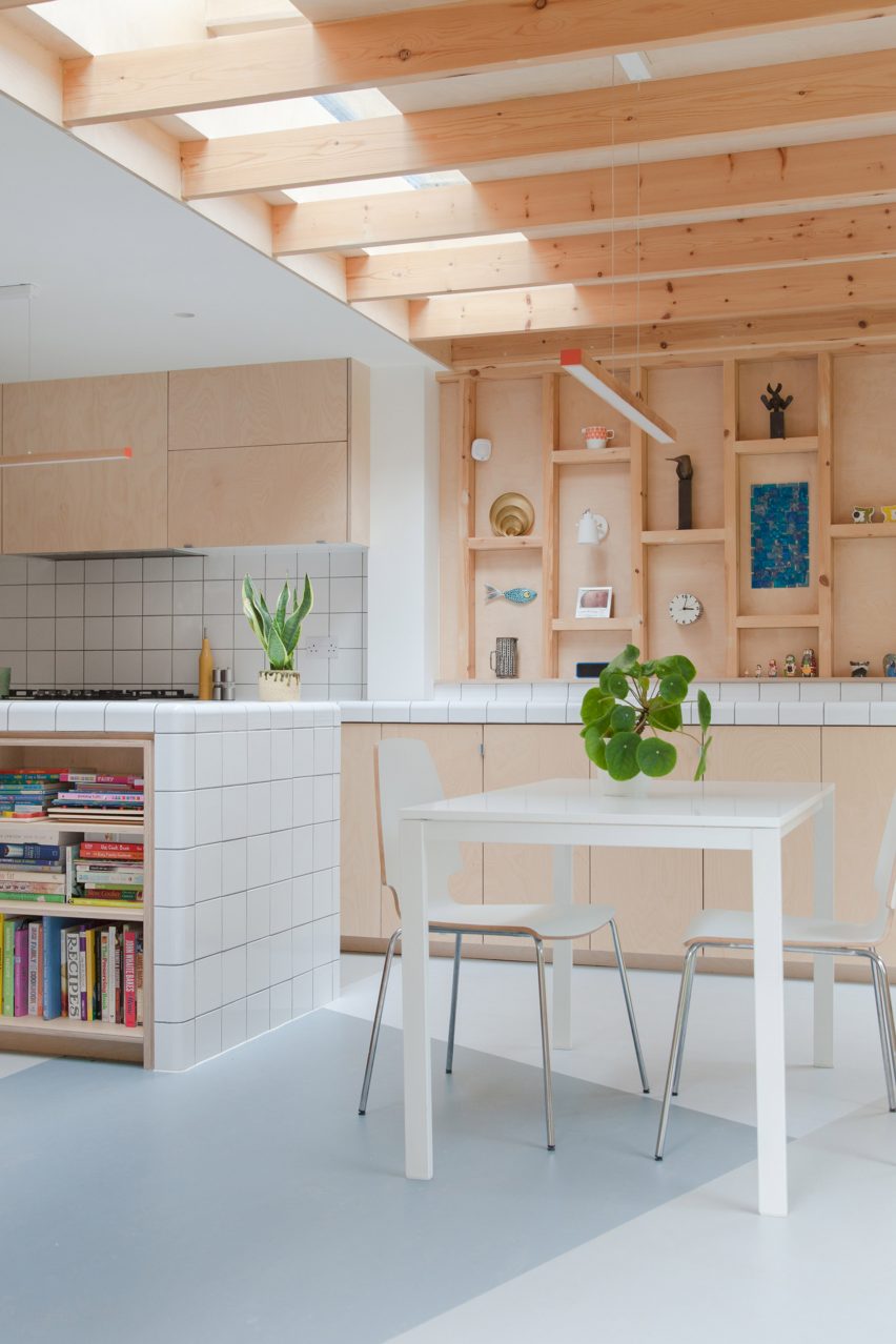 A kitchen with wooden walls and cabinets