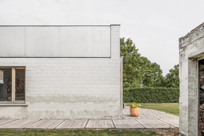 The pale brick facade of a Belgian bungalow
