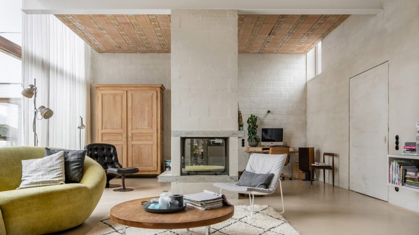 A living room with roughly plastered walls