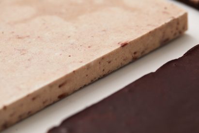 Bio-concrete tiles in peach and burgundy made from American signal crayfish and Japanese knotweed