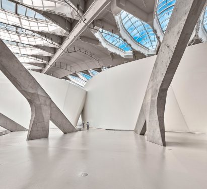 Concrete struts and white fabric walls
