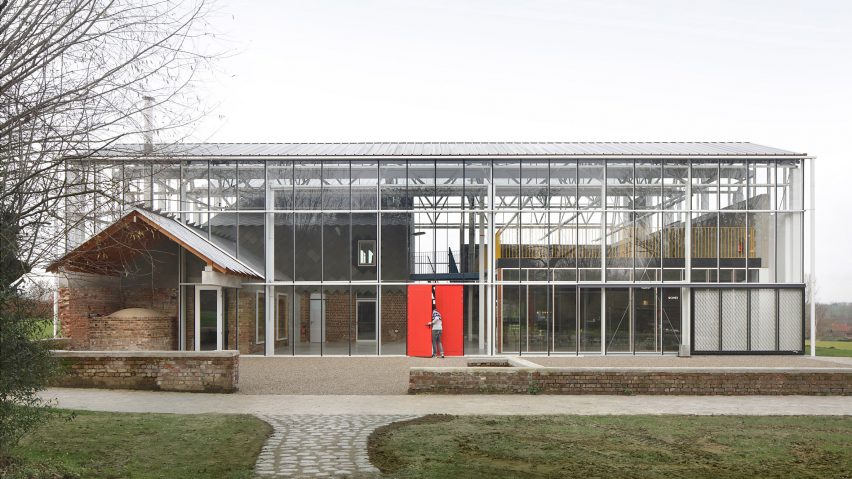 A greenhouse-like structure containing agricultural buildings