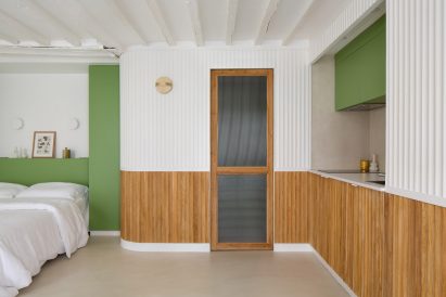 A curved partition wall wraps around the space by Pierre-Louis Gerlier Architecte