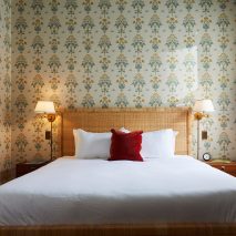 Post House Inn bedroom with printed wallpaper