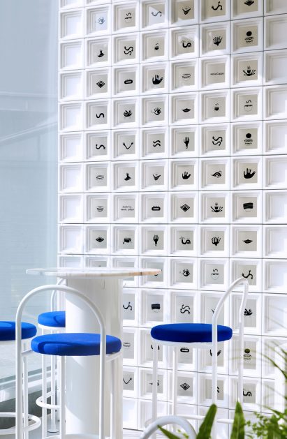 Wall of white cubes and small seating area in Shanghai's Mini Cuppa cafe