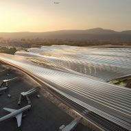 The terminal has a sweeping roof by Rogers Stirk Harbour + Partners