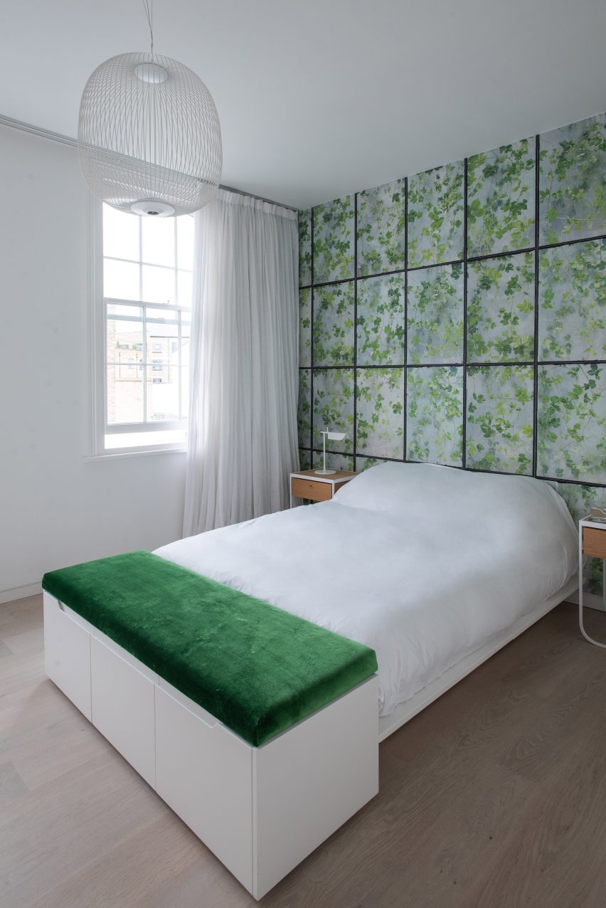 Leaf-patterned wall in white bedroom