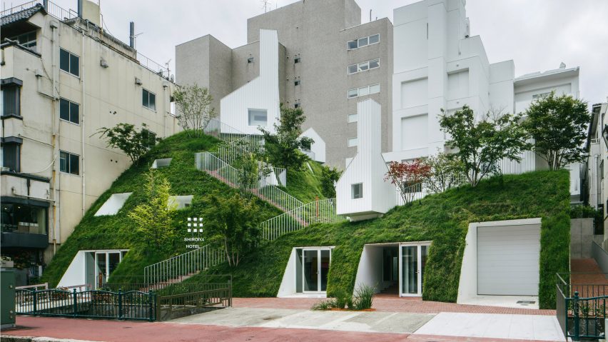 A hotel with suites on a grassy hill