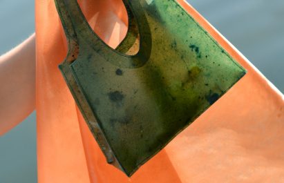Green bag made from fruit peels by made from fruit peels by Lobke Beckfeld and Johanna Hehemeyer-Cürten alongside a swatch of the fruit leather in peach