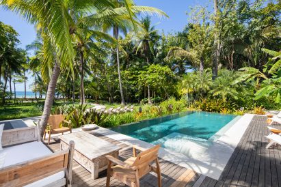 The swimming pool is surrounded by trees