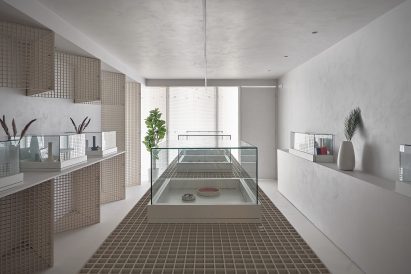 Cannabis dispensary with industrial grating walls and displays by StudioAC