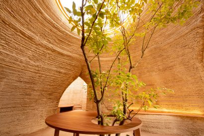 The housing prototype has textural walls from its stacked clay form by Mario Cucinella Architects and Wasp
