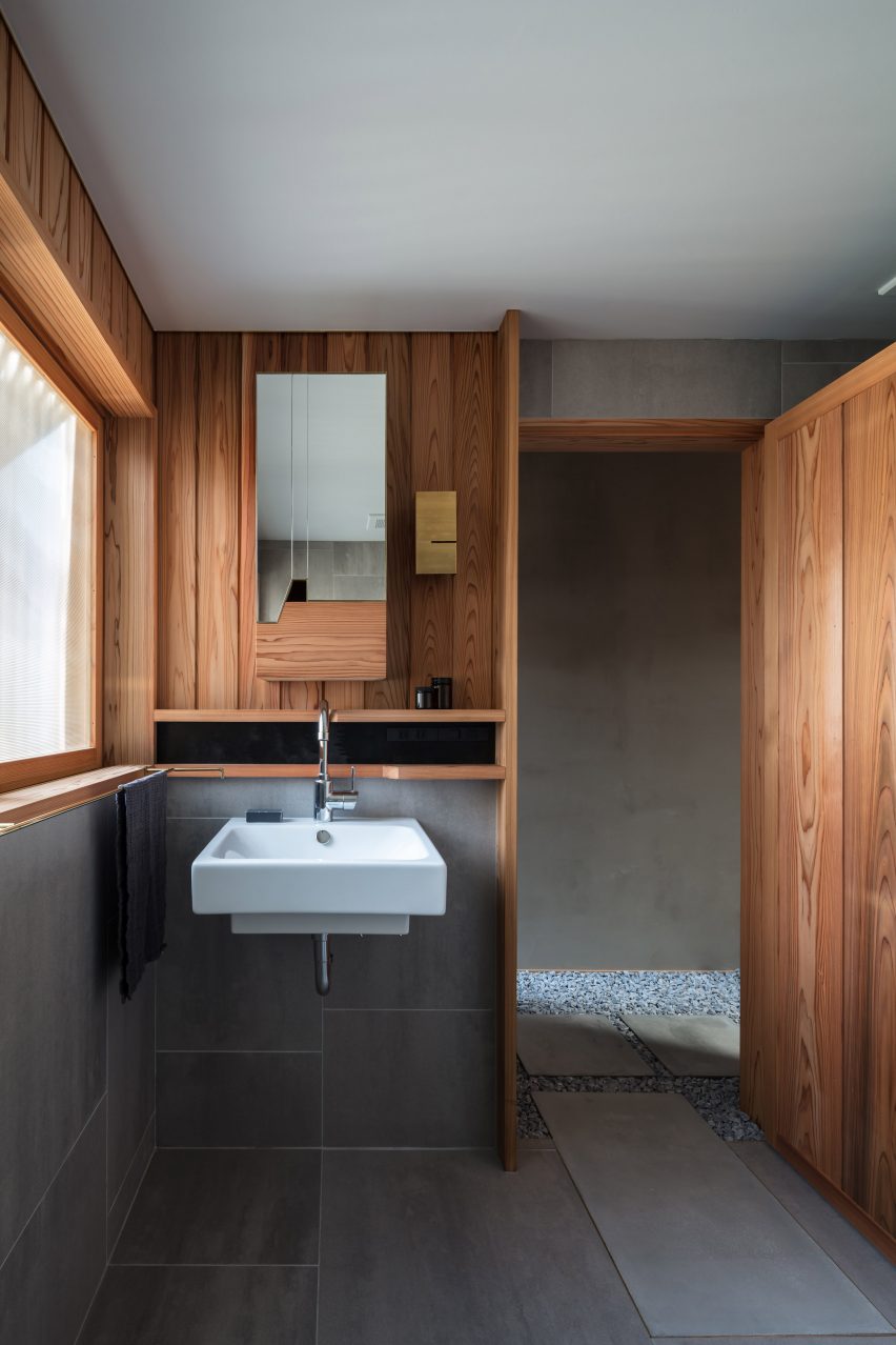 A bathroom lined with wood and tiles