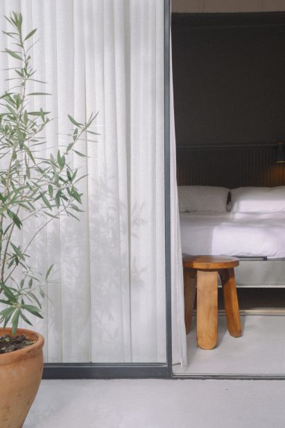 A bedroom with a glazed wall