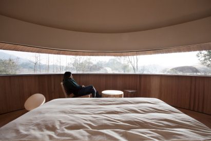A bedroom with a panoramic window
