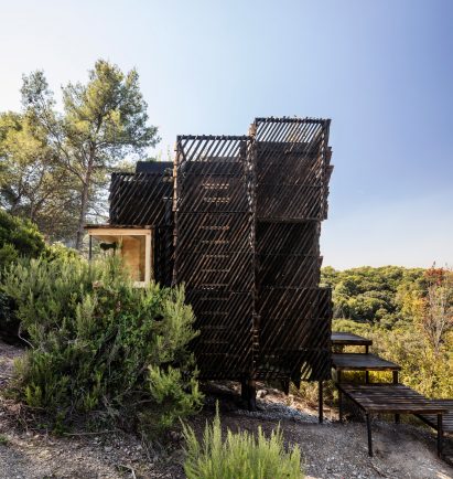 A cabin wrapped in slatted panels