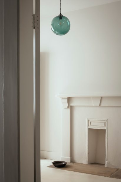 Fireplace in bedroom of London apartment renovation by Daab Design