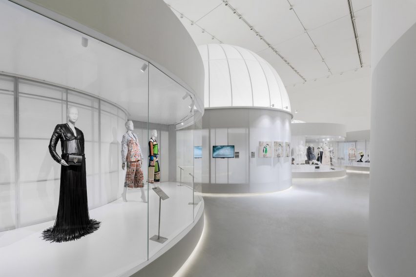 Curved display cabinets are organised around the exhibition
