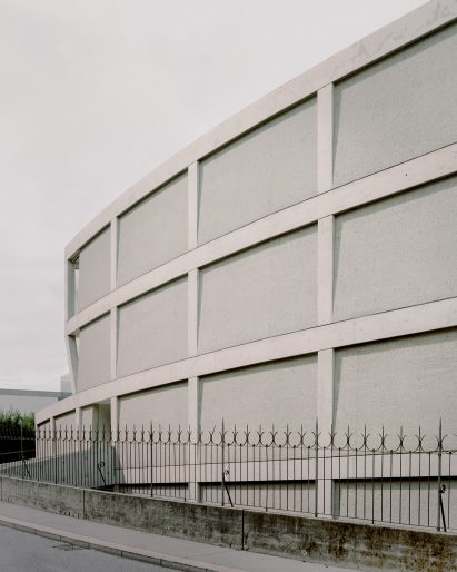 It has a gridded facade with bush-hammered panels by DF_DC