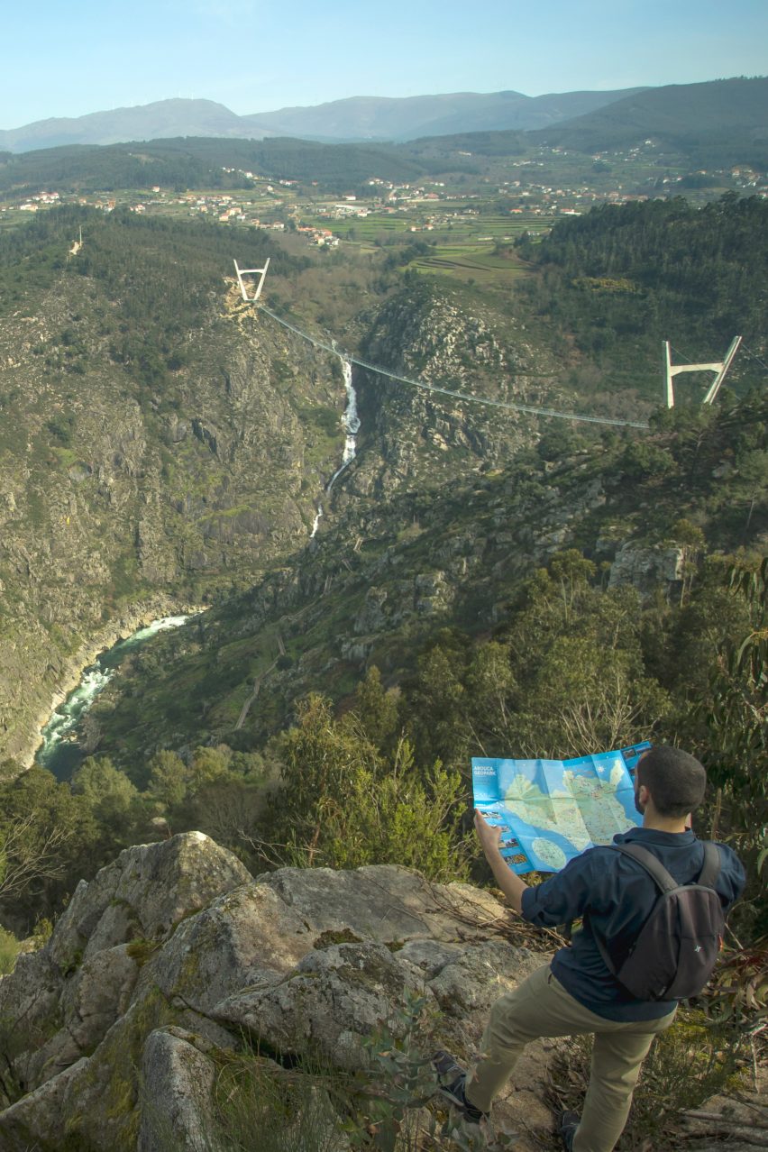 The bridge links to rocky hills