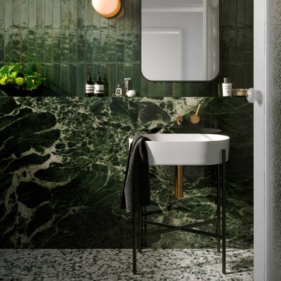 Green bathroom with complementary tile combination from Grand Marble Look collection