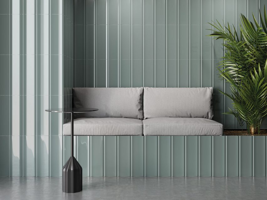 Concave grey-green wall tiles clad a seating nook