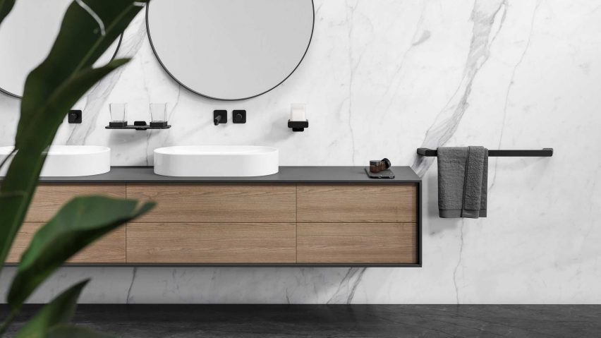 Hotel bathroom with black accessories and round mirror