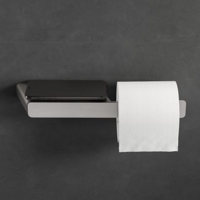 Mobile phone on the shelf of a toilet roll holder