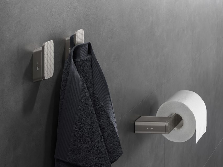 Brushed stainless steel bathroom accessories mounted on wall
