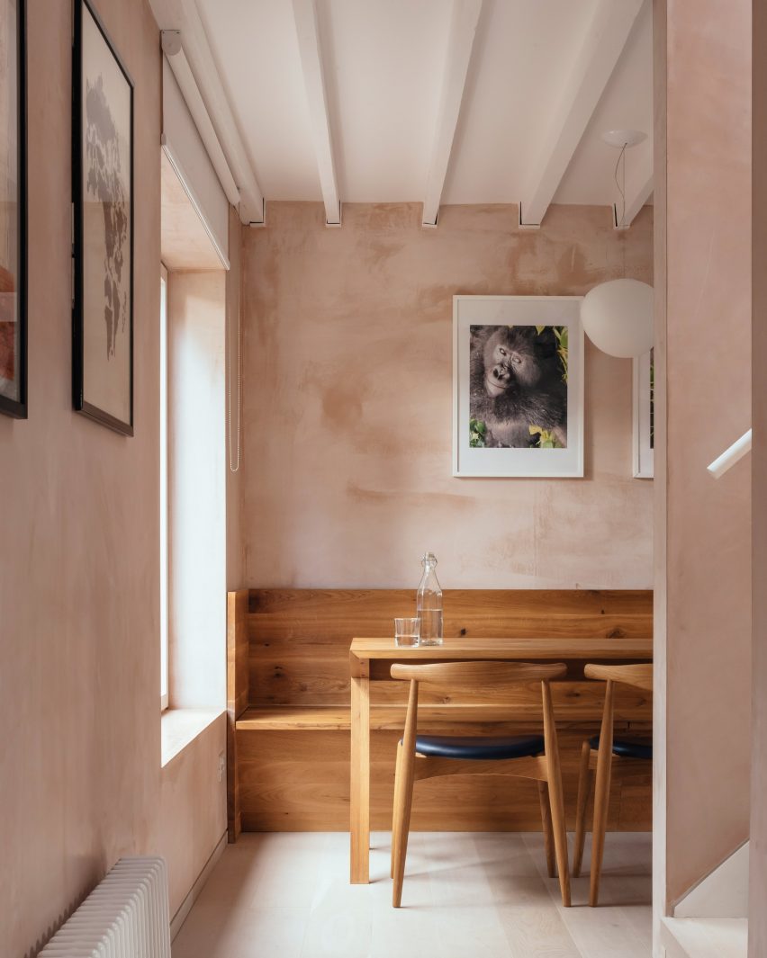 Oak dining table with light coming through a large window