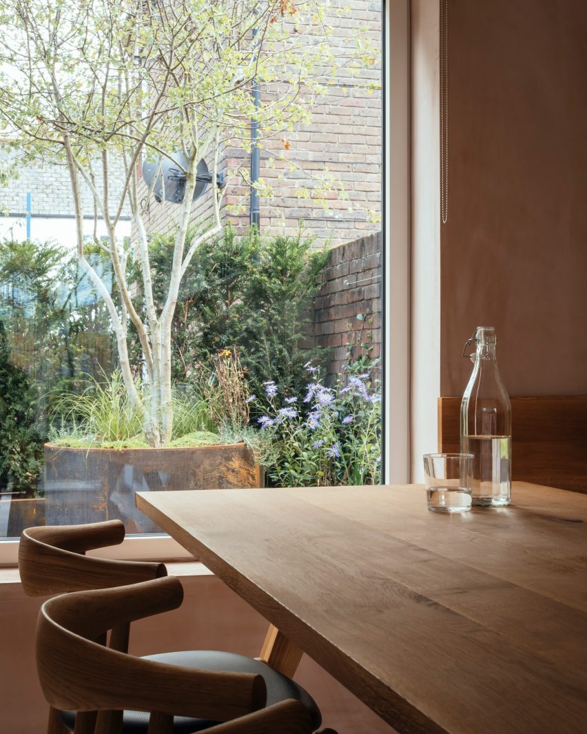 Oak dining table by a large window
