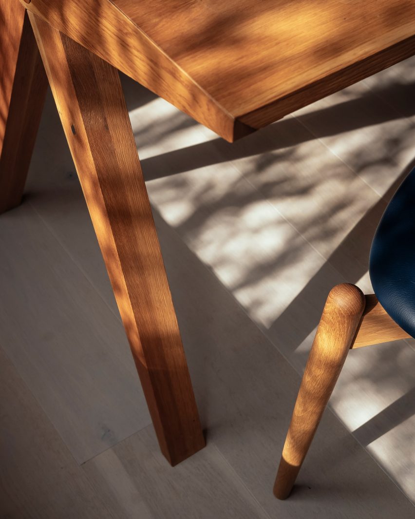 Shadows cast on the corner of an oak dining table