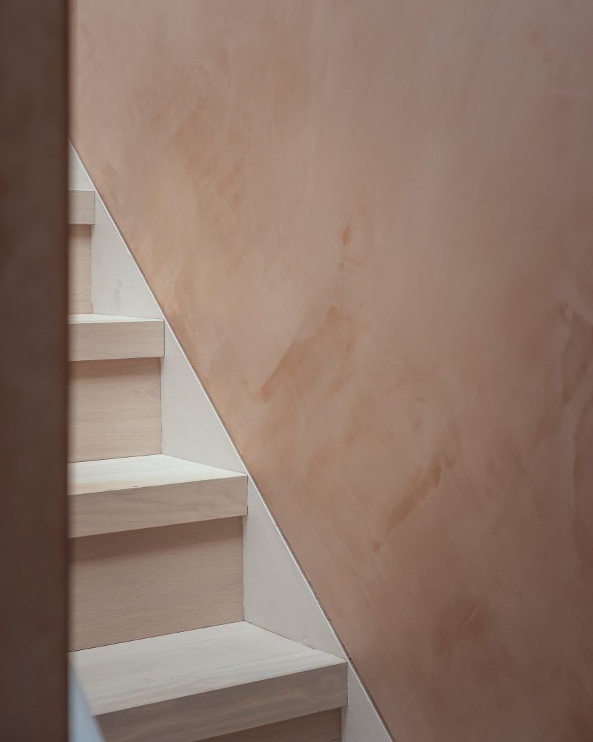 White-washed oak staircase and textured plaster walls