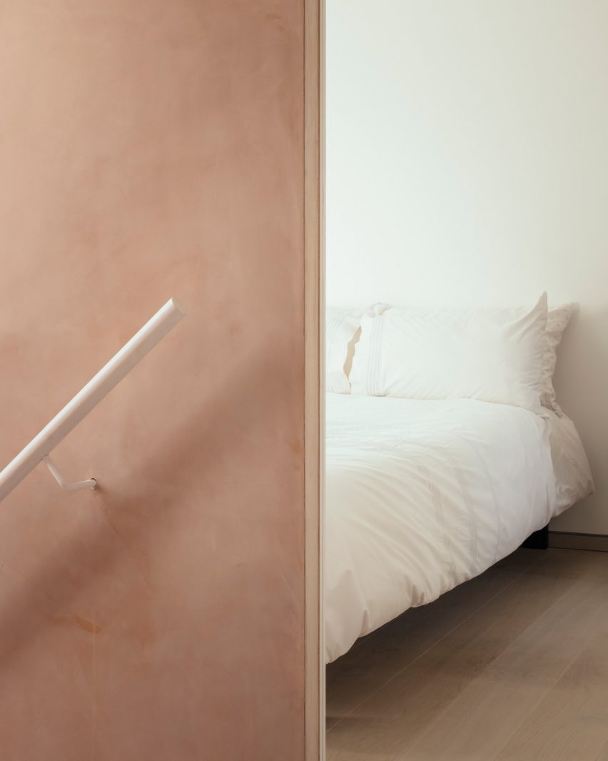 White bedroom viewed from landing