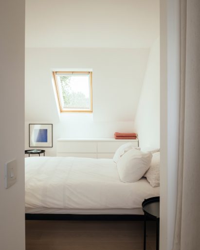 White bedroom with roof light