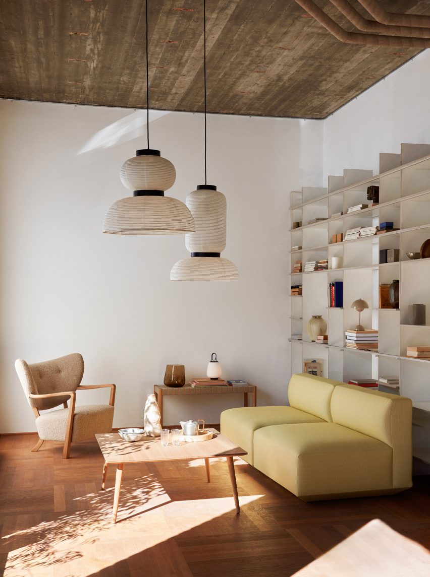 Wooden armchair with beige upholstery by &Tradition in a living room with a yellow sofa
