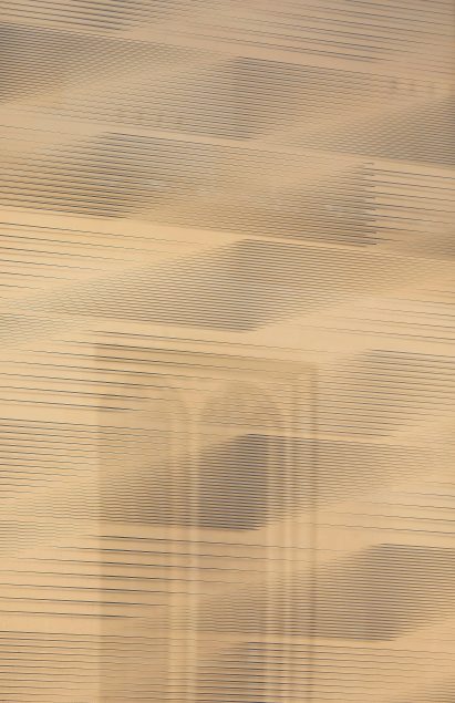 The facade reflects the stone coloured surroundings by AL_A