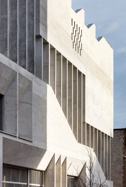 Light hits the building forming geometric shadows