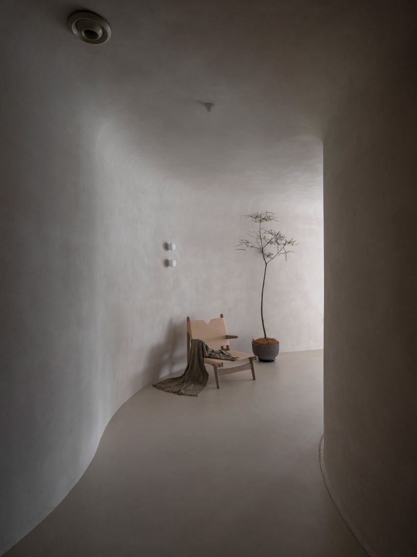 A plant and seating are placed against the walls