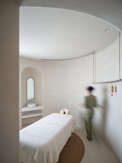 A spa bed is located in the centre of a treatment room at Soul Realm Spa