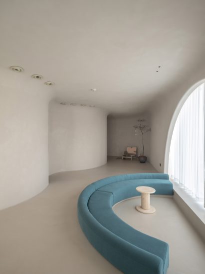 A blue sofa is located at the waiting area of Soul Realm Spa