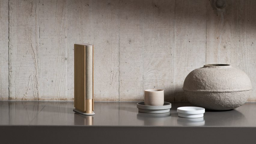 The Beosound Speaker has a gold and oak finish