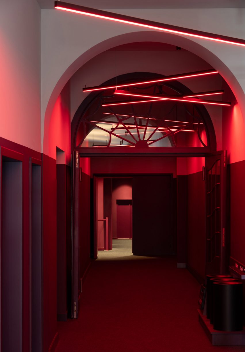Red cinema hallway with neon lights