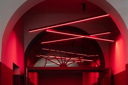 Neon lights decorate a red ceiling